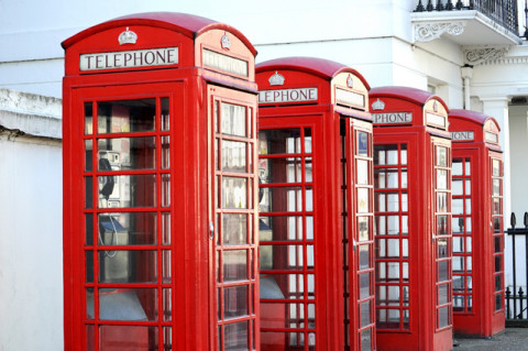 Row of red telephone boxes in London street