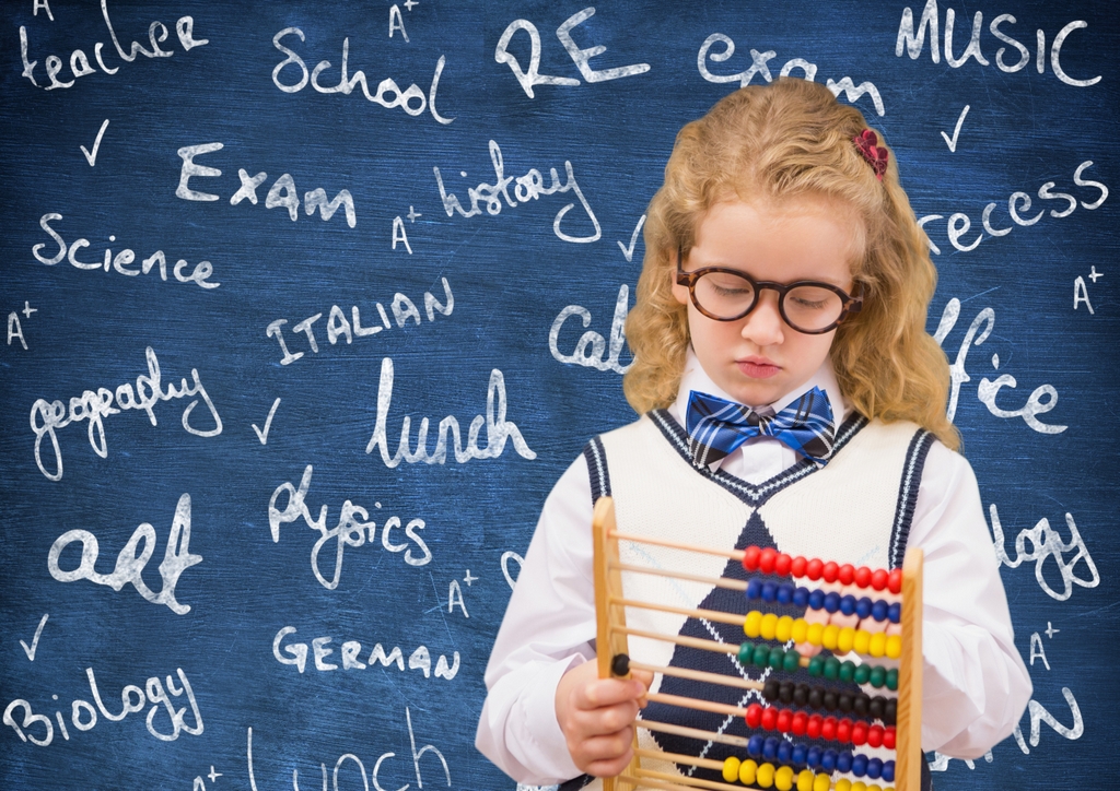 Digital composite image of schoolgirl holding abacus against chalkboard
